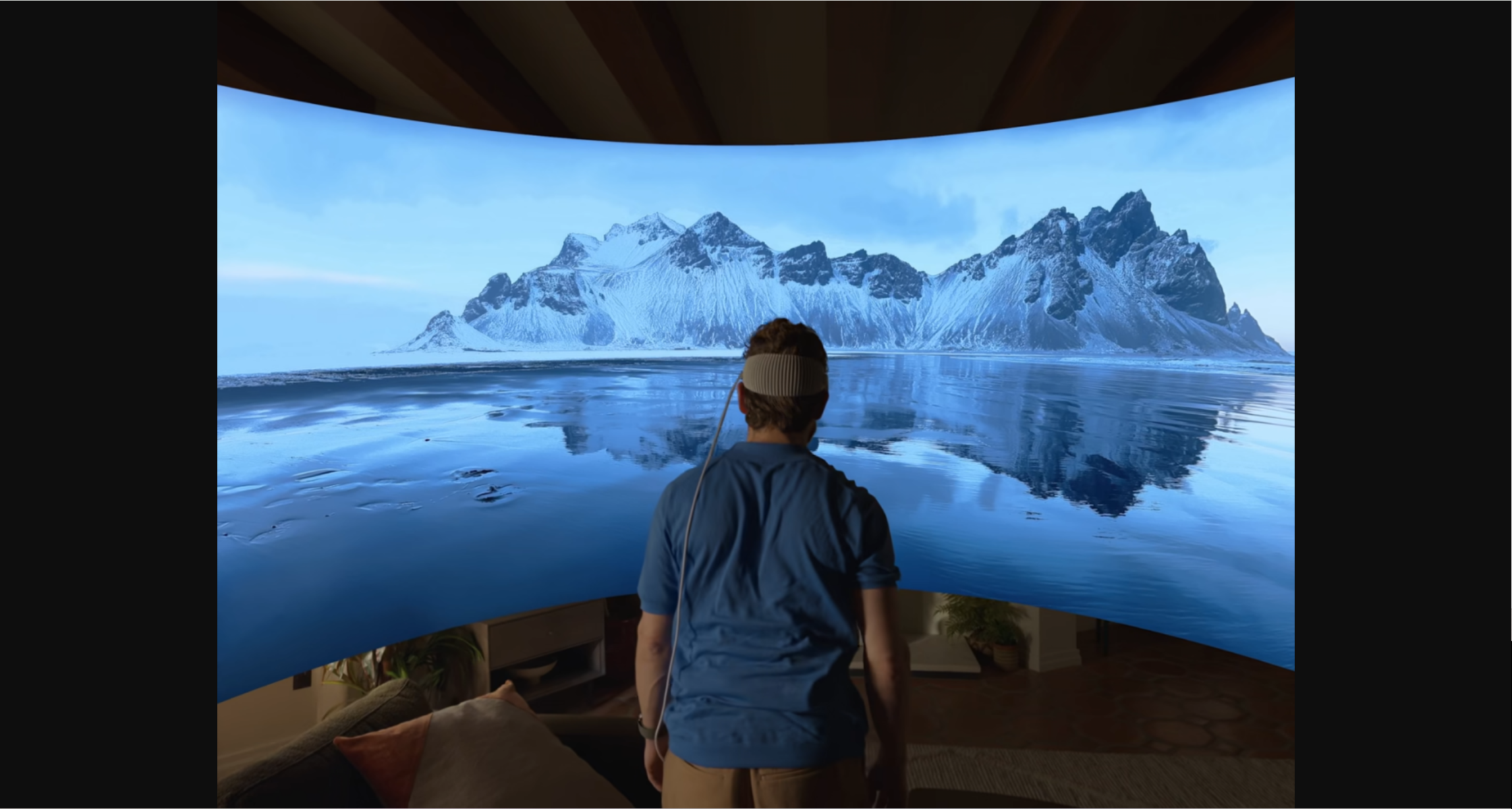 A man using Apple Vision Pro with The Environments feature, watching iceberg in front of him