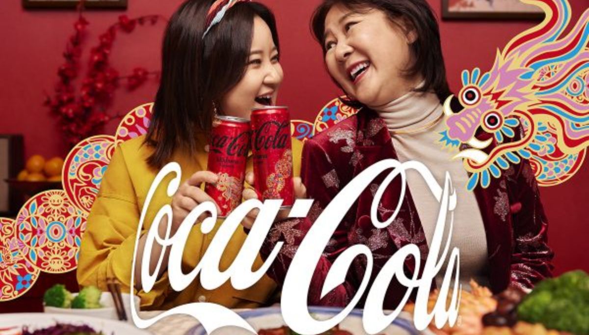 2 women enjoying their Coca Cola drink with AR Dragon surrounding them