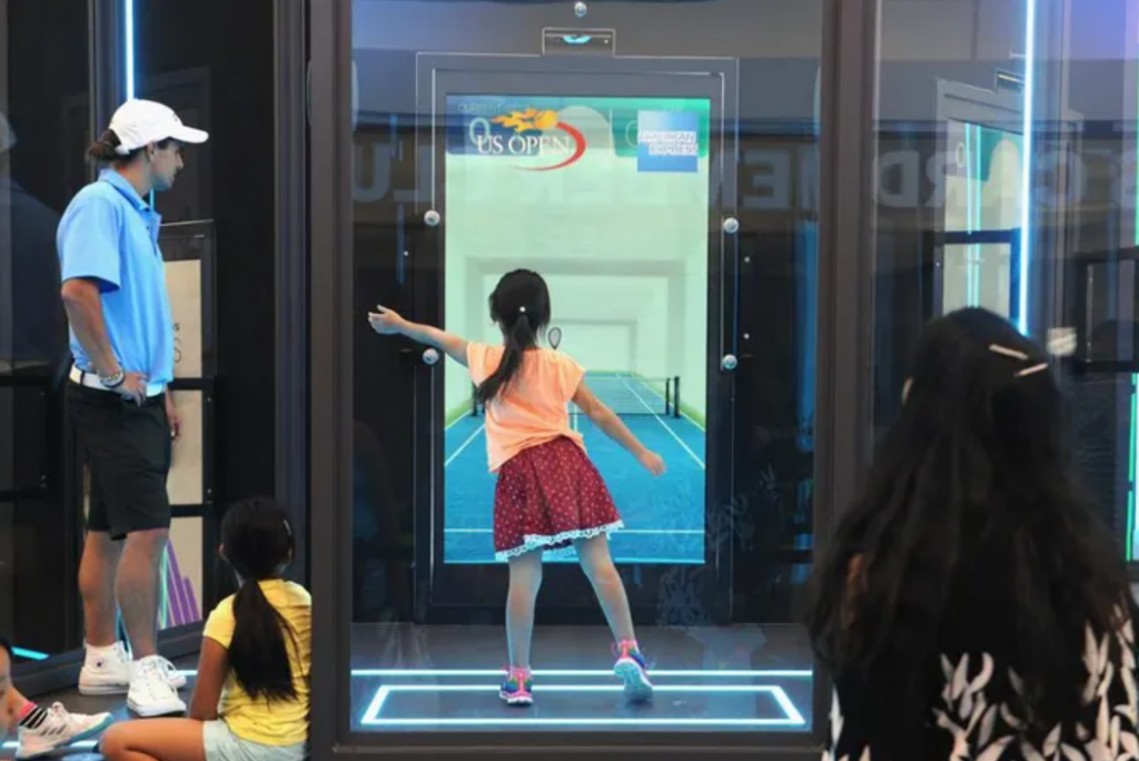 A girl playing with kiosk as part of experiential marketing tactics